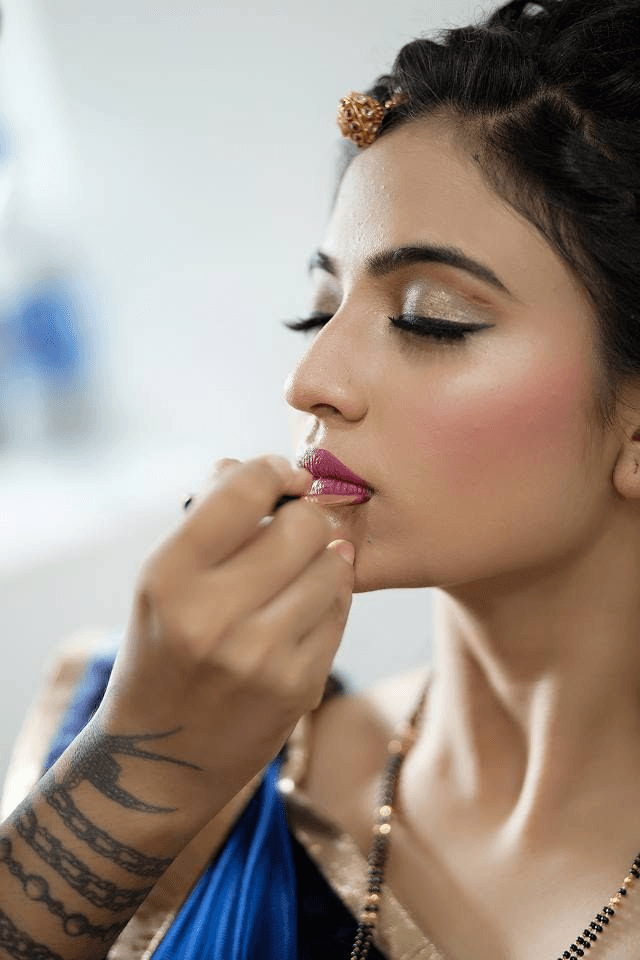 Makeup artist applying lipstick